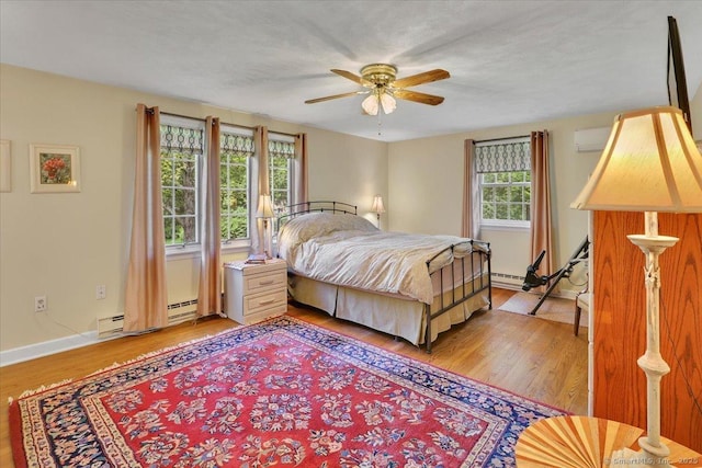 190 Bronson Dr, Middlebury, CT 06762 - bedroom featuring light wood-style flooring, a baseboard radiator, a wall mounted air conditioner, and baseboards