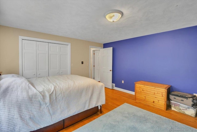 190 Bronson Dr, Middlebury, CT 06762 - bedroom with wood finished floors, baseboards, and a closet