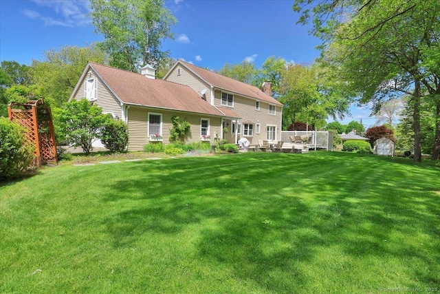 190 Bronson Dr, Middlebury, CT 06762 - back of house featuring a chimney and a lawn