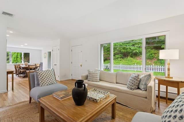 11 Valley Rd, Westport, CT 06880 - living room featuring a baseboard heating unit, light wood-type flooring, recessed lighting, and baseboards