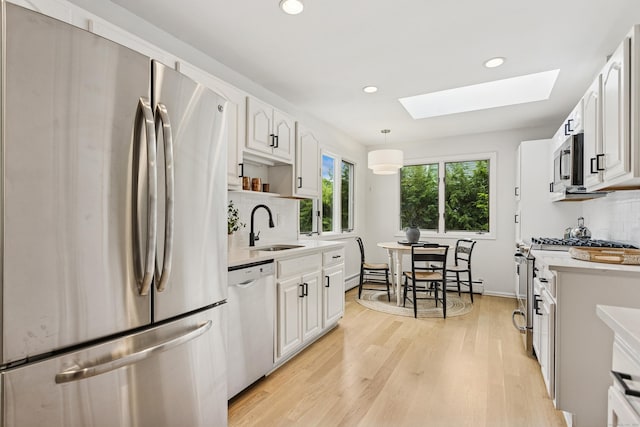 11 Valley Rd, Westport, CT 06880 - kitchen featuring stainless steel appliances, a skylight, a sink, tasteful backsplash, and recessed lighting