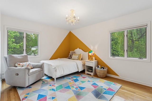11 Valley Rd, Westport, CT 06880 - bedroom featuring multiple windows, wood finished floors, a chandelier, and baseboards