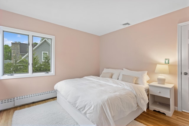 11 Valley Rd, Westport, CT 06880 - bedroom featuring a baseboard radiator, light wood-type flooring, and baseboards