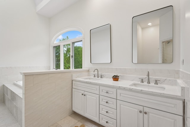 11 Valley Rd, Westport, CT 06880 - bathroom featuring double vanity, tile patterned flooring, and tiled tub