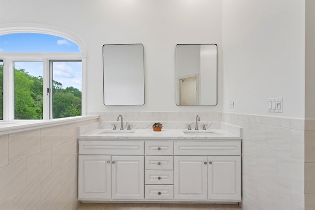 11 Valley Rd, Westport, CT 06880 - full bathroom featuring tile walls, double vanity, and wainscoting
