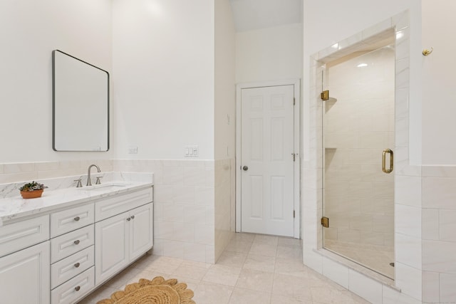 11 Valley Rd, Westport, CT 06880 - full bathroom featuring tile walls, vanity, a shower stall, tile patterned floors, and wainscoting