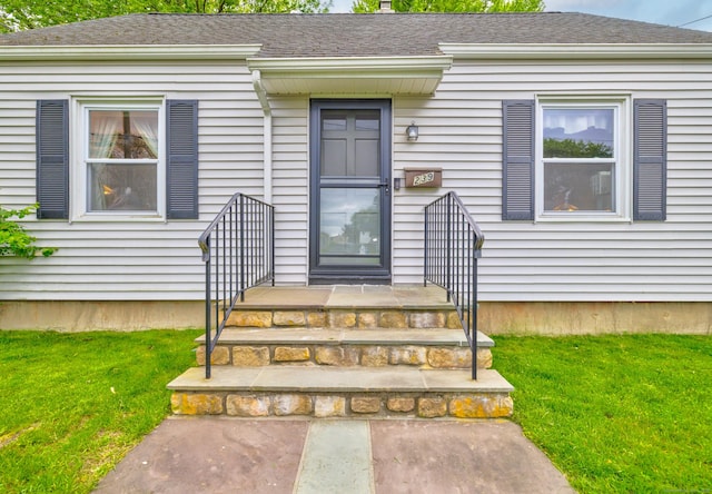 239 Old Field Ln, Milford, CT 06460 - view of exterior entry featuring a lawn and roof with shingles