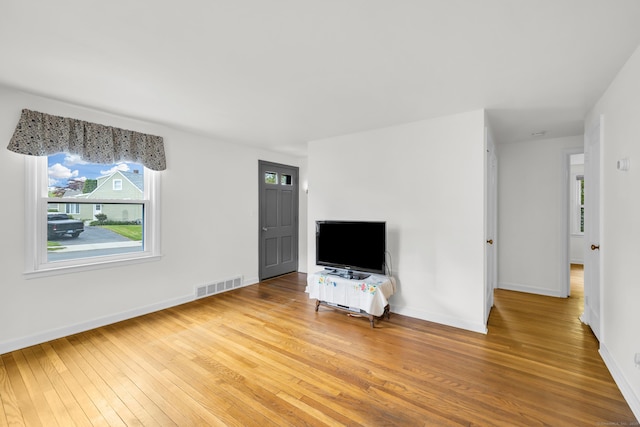 239 Old Field Ln, Milford, CT 06460 - unfurnished living room featuring hardwood / wood-style flooring and baseboards
