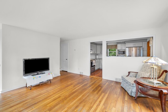 239 Old Field Ln, Milford, CT 06460 - living area with hardwood / wood-style floors and baseboards
