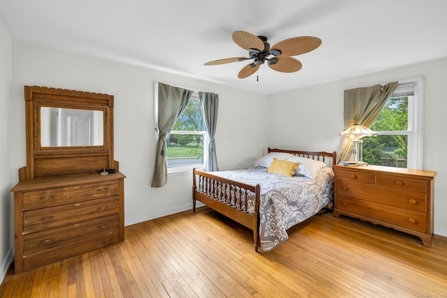239 Old Field Ln, Milford, CT 06460 - bedroom featuring multiple windows, light wood-style floors, baseboards, and a ceiling fan