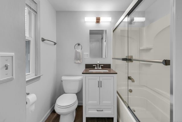 239 Old Field Ln, Milford, CT 06460 - bathroom with toilet, vanity, wood finished floors, enclosed tub / shower combo, and baseboards