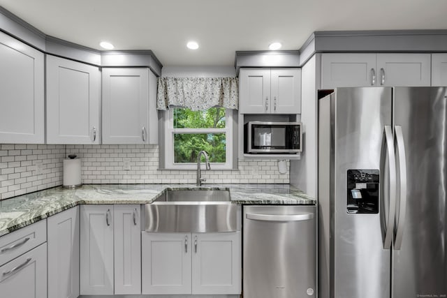 239 Old Field Ln, Milford, CT 06460 - kitchen featuring appliances with stainless steel finishes, a sink, backsplash, light stone counters, and recessed lighting