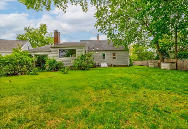 239 Old Field Ln, Milford, CT 06460 - rear view of house featuring a chimney
