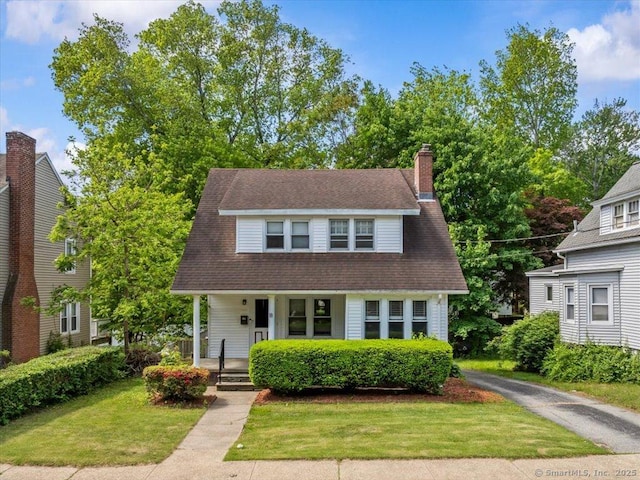 18 Geer Ave, Norwich, CT 06360 - view of front facade featuring a porch, a front yard, and a chimney