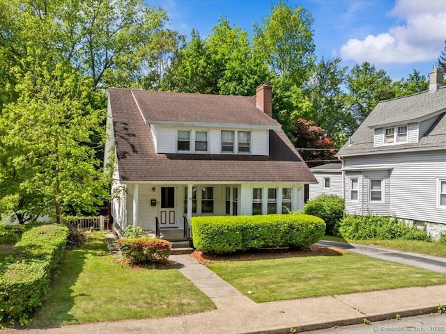 18 Geer Ave, Norwich, CT 06360 - view of front of house featuring covered porch, a front lawn, and a chimney