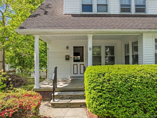 18 Geer Ave, Norwich, CT 06360 - doorway to property featuring covered porch and roof with shingles