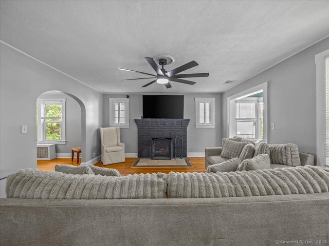 18 Geer Ave, Norwich, CT 06360 - living room with a ceiling fan, wood finished floors, plenty of natural light, arched walkways, and a textured ceiling
