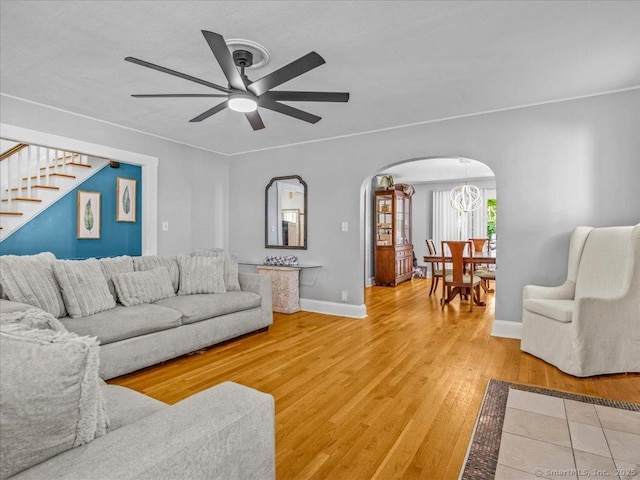 18 Geer Ave, Norwich, CT 06360 - living area with arched walkways, a ceiling fan, stairway, light wood-style floors, and baseboards