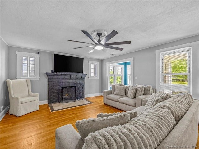 18 Geer Ave, Norwich, CT 06360 - living room featuring a textured ceiling, a ceiling fan, wood finished floors, plenty of natural light, and baseboards