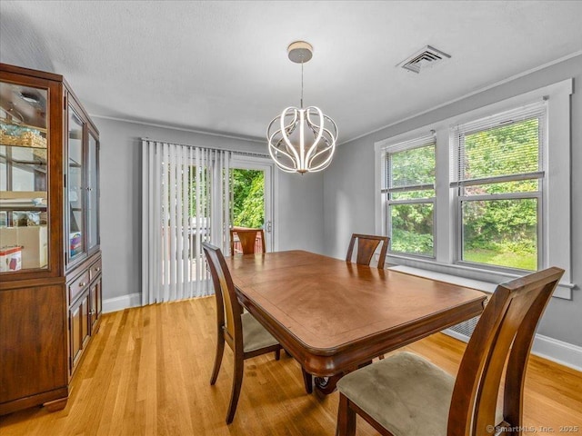 18 Geer Ave, Norwich, CT 06360 - dining area with a chandelier, light wood-style floors, and baseboards