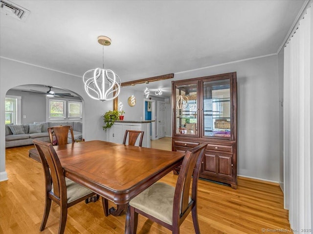 18 Geer Ave, Norwich, CT 06360 - dining area featuring arched walkways, light wood-type flooring, a chandelier, ornamental molding, and baseboards