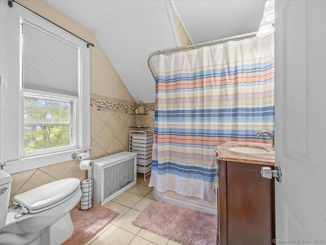 18 Geer Ave, Norwich, CT 06360 - bathroom featuring tile walls, tile patterned flooring, vaulted ceiling, toilet, and vanity