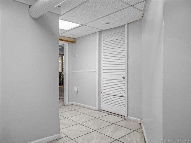 18 Geer Ave, Norwich, CT 06360 - corridor with a paneled ceiling, baseboards, and light tile patterned flooring