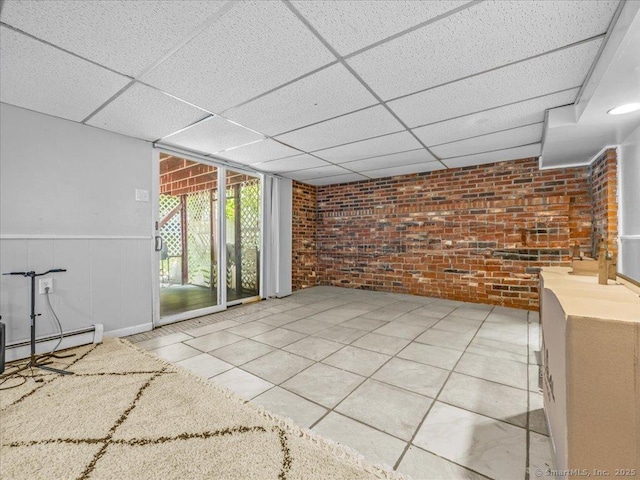 18 Geer Ave, Norwich, CT 06360 - spare room with brick wall, a paneled ceiling, a baseboard heating unit, and wainscoting