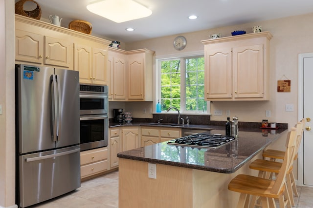15 Ledge Rd, Southington, CT 06489 - kitchen with appliances with stainless steel finishes, a sink, a peninsula, dark stone counters, and a kitchen breakfast bar