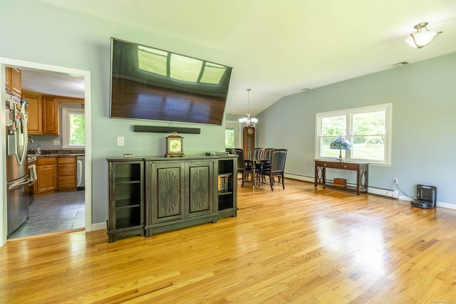 55 Linton St, Torrington, CT 06790 - living room featuring a chandelier, light wood-type flooring, vaulted ceiling, and baseboards
