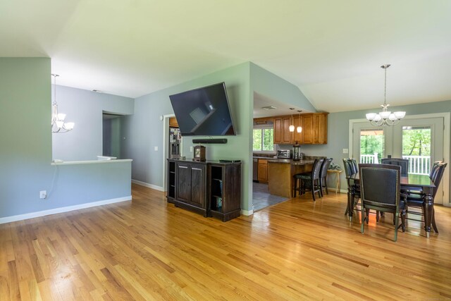 55 Linton St, Torrington, CT 06790 - kitchen featuring a chandelier, dark countertops, brown cabinets, and light wood-style floors