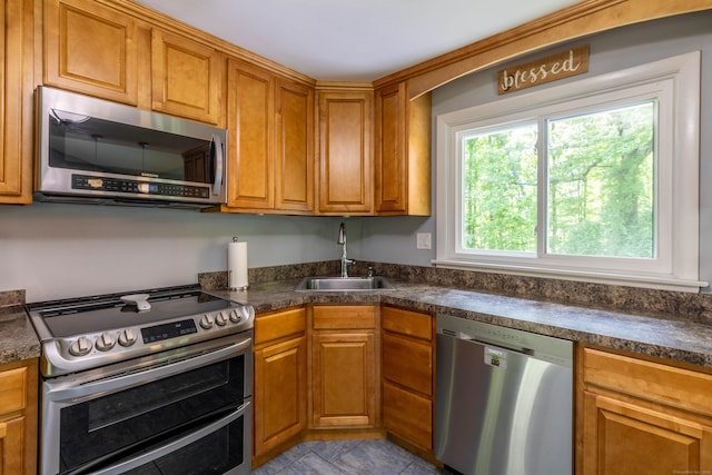 55 Linton St, Torrington, CT 06790 - kitchen with appliances with stainless steel finishes, a sink, dark countertops, and brown cabinets