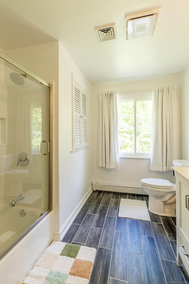 55 Linton St, Torrington, CT 06790 - full bath featuring a baseboard heating unit, toilet, vanity, wood tiled floors, and shower / bath combination with glass door