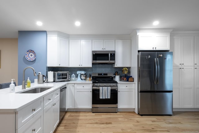 21 Summer Brook Way, Seymour, CT 06483 - kitchen with stainless steel appliances, a sink, light countertops, decorative backsplash, and white cabinetry