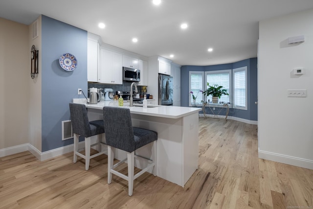 21 Summer Brook Way, Seymour, CT 06483 - kitchen featuring stainless steel appliances, a sink, a peninsula, a breakfast bar, and light countertops