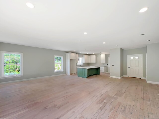 67 Fairfield Pl, Beacon Falls, CT 06403 - unfurnished living room with baseboards, light wood-style floors, and recessed lighting