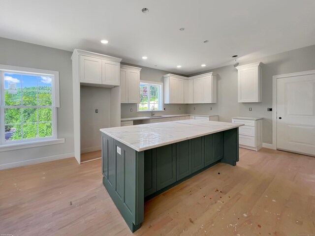67 Fairfield Pl, Beacon Falls, CT 06403 - kitchen with white cabinets, baseboards, light wood finished floors, a sink, and recessed lighting
