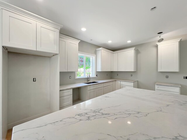 67 Fairfield Pl, Beacon Falls, CT 06403 - kitchen with a sink, light stone countertops, recessed lighting, and white cabinetry