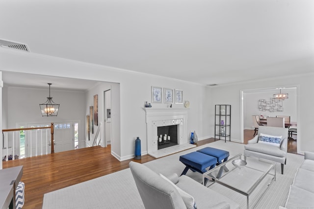 53 Pinnacle Rock Rd, Stamford, CT 06903 - living area with a chandelier, wood finished floors, crown molding, a high end fireplace, and baseboards