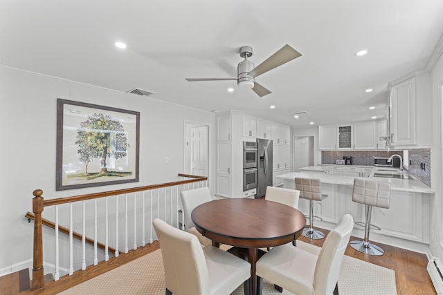53 Pinnacle Rock Rd, Stamford, CT 06903 - dining space with a baseboard radiator, recessed lighting, ceiling fan, wood finished floors, and crown molding
