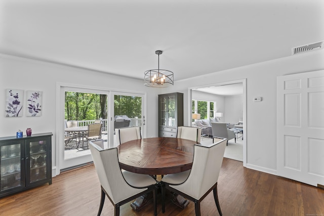 53 Pinnacle Rock Rd, Stamford, CT 06903 - dining area with wood finished floors, a chandelier, crown molding, and baseboards