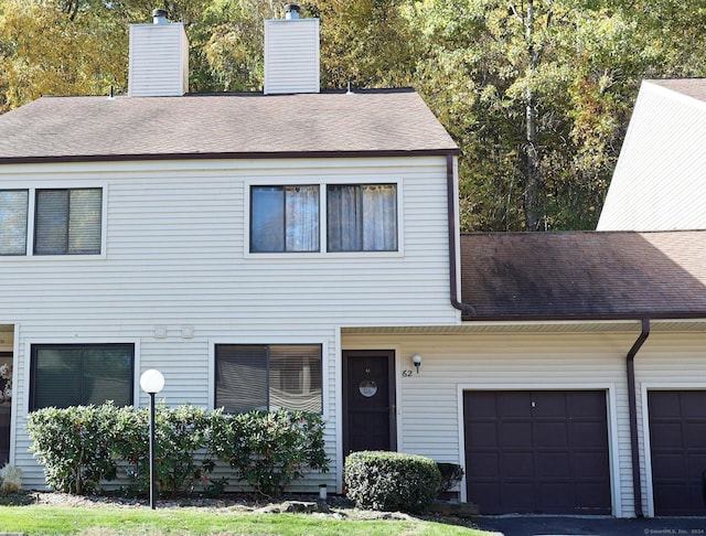 62 Deer Run Unit 62, Bethel, CT 06801 - view of property featuring a chimney, roof with shingles, and an attached garage