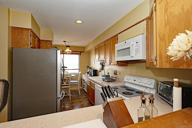 62 Deer Run Unit 62, Bethel, CT 06801 - kitchen with white appliances, light countertops, brown cabinetry, recessed lighting, and a sink