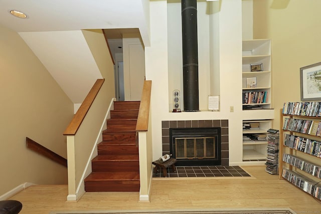 62 Deer Run Unit 62, Bethel, CT 06801 - stairway with wood finished floors, a tiled fireplace, and baseboards