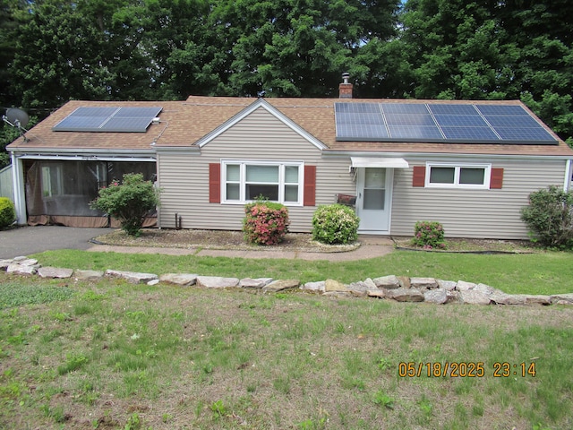 37 Stepney Cir, Rocky Hill, CT 06067 - single story home with a chimney, solar panels, a front lawn, and roof with shingles