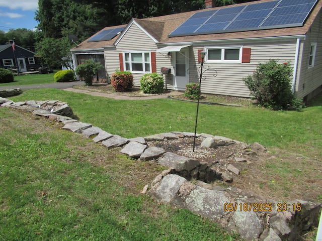 37 Stepney Cir, Rocky Hill, CT 06067 - view of front of property featuring a front yard, roof mounted solar panels, a chimney, and a shingled roof
