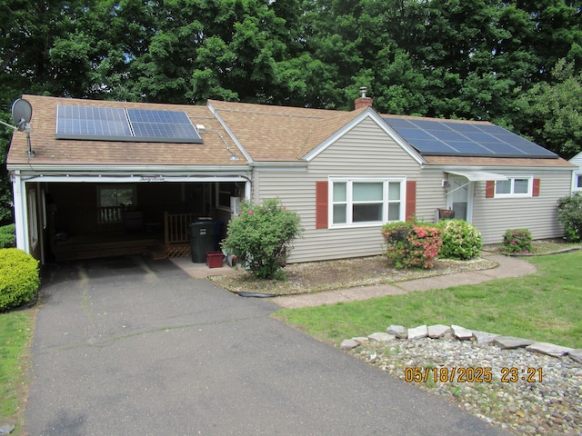 37 Stepney Cir, Rocky Hill, CT 06067 - ranch-style house featuring roof mounted solar panels, a chimney, driveway, a garage, and a shingled roof