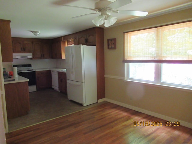 37 Stepney Cir, Rocky Hill, CT 06067 - kitchen with white appliances, under cabinet range hood, light countertops, baseboards, and wood finished floors