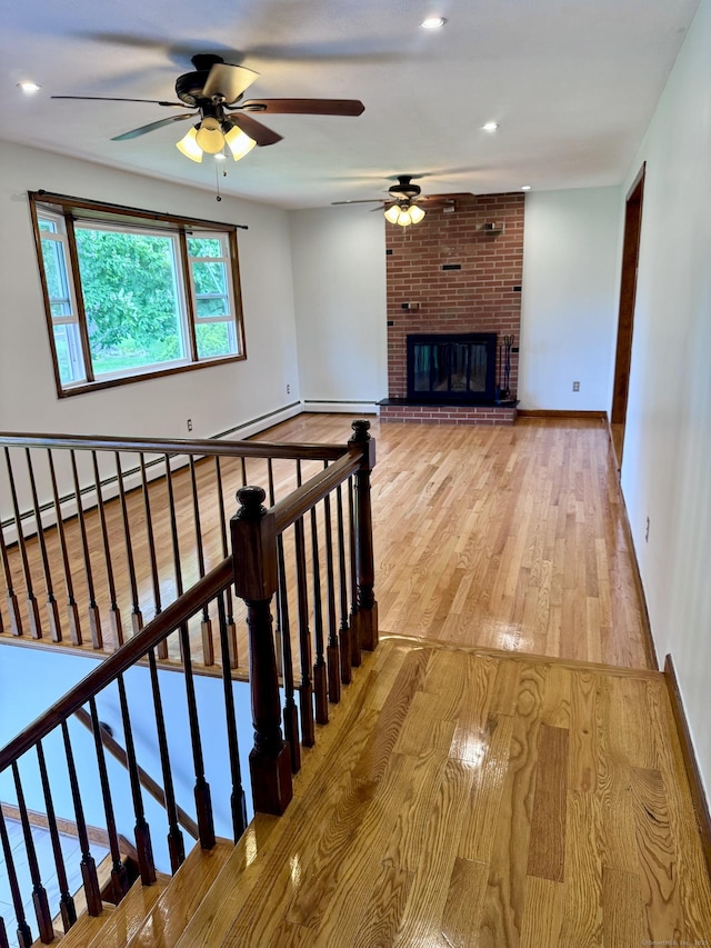 588 Poquonock Ave, Windsor, CT 06095 - unfurnished living room with ceiling fan, wood finished floors, a baseboard heating unit, and baseboards