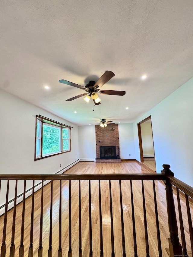 588 Poquonock Ave, Windsor, CT 06095 - unfurnished living room featuring ceiling fan, a brick fireplace, light wood-style flooring, baseboards, and recessed lighting